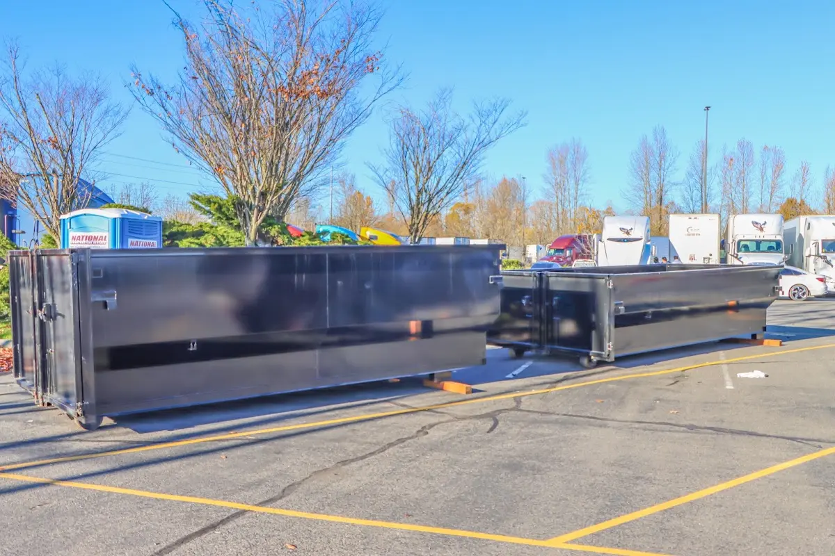 Professional dumpster rental service with roll-off container on residential driveway in West Odessa
